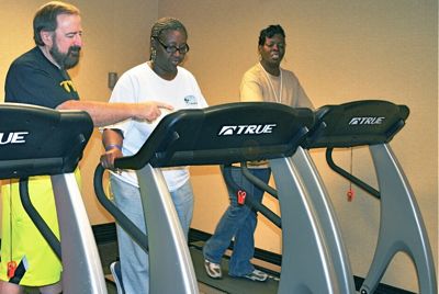 Reverend Moseley helps clients use cardio equipment